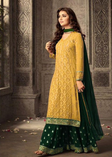 a woman wearing yellow dress and green pallazzo set with green dupatta