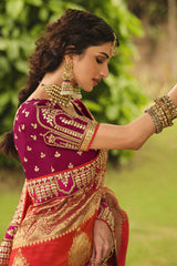 Orange Saree with Maroon Blouse.