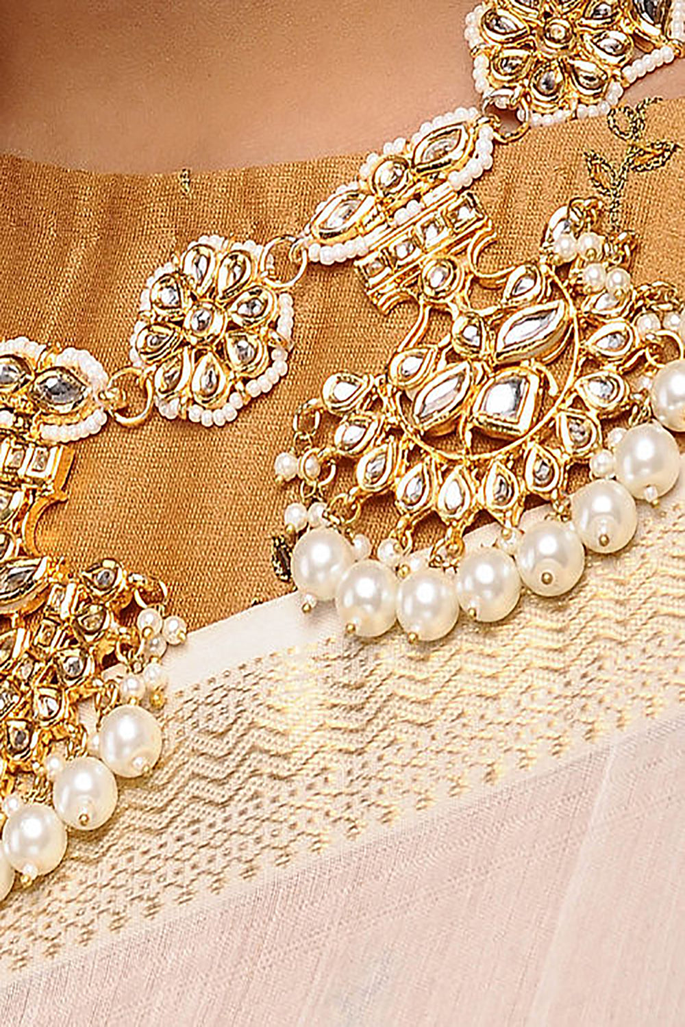 Alloy Kundan Neckpiece With Earrings In Gold And White