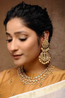 Alloy Kundan Neckpiece With Earrings In Gold And White